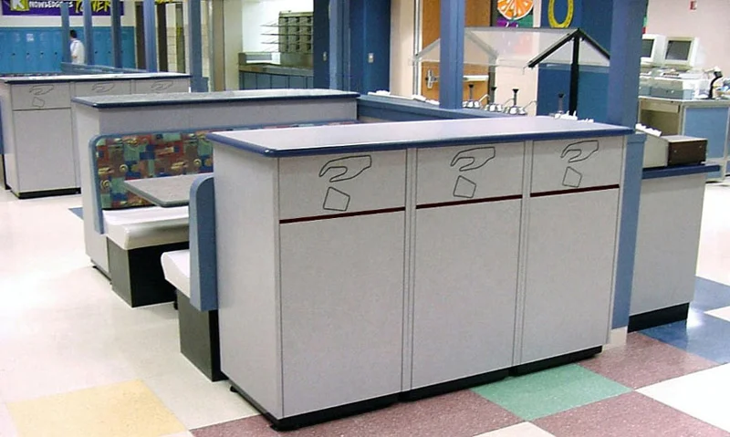 Triple Waste Receptacles with Universal Symbol Flip Door In High School Cafeteria